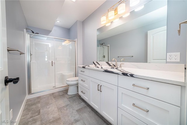 bathroom with toilet, a shower with door, and vanity