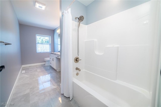 full bathroom featuring shower / bath combo, toilet, and vanity