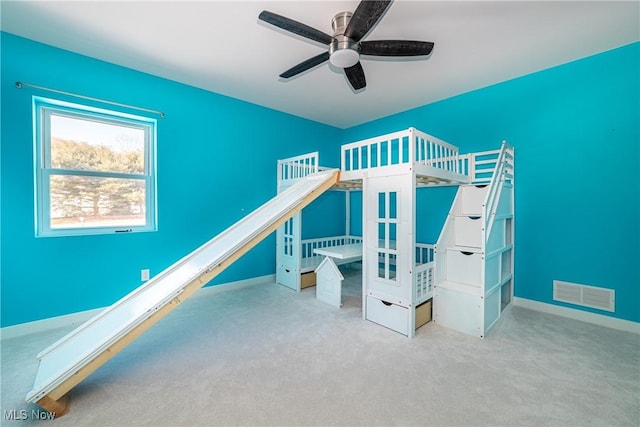 unfurnished bedroom featuring ceiling fan and light colored carpet