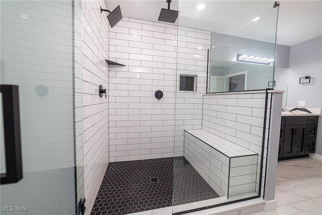 bathroom with vanity and a shower with door