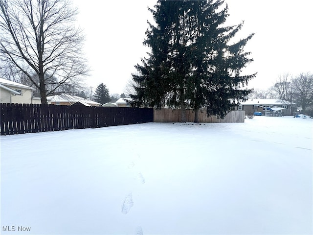 view of yard layered in snow