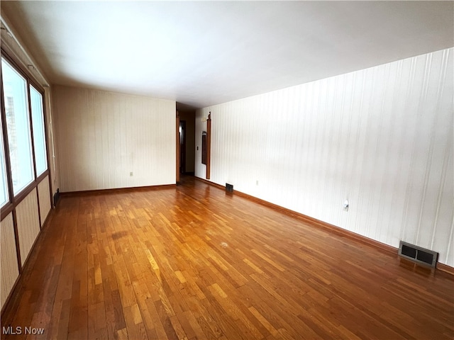 unfurnished room featuring hardwood / wood-style flooring