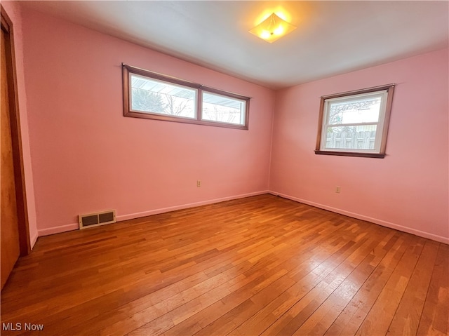 empty room with light hardwood / wood-style floors