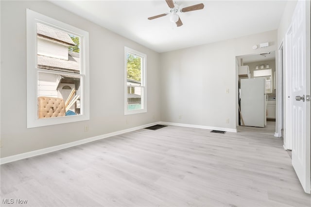 spare room with ceiling fan and light hardwood / wood-style flooring