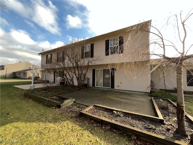 rear view of house featuring a patio area and a yard