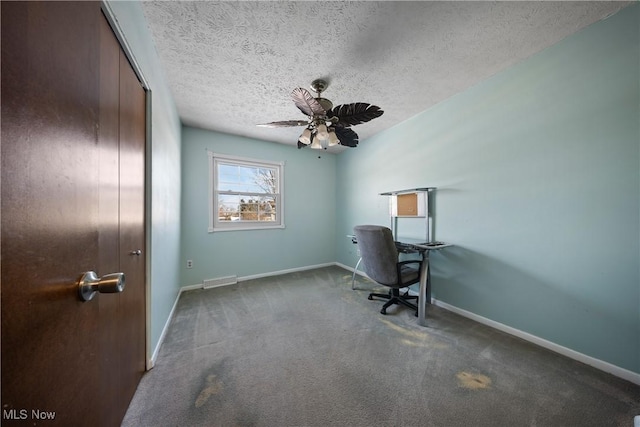 unfurnished office with ceiling fan, carpet flooring, and a textured ceiling