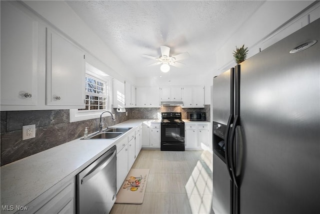 kitchen featuring white cabinets, appliances with stainless steel finishes, decorative backsplash, sink, and ceiling fan