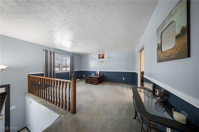 carpeted living room featuring a textured ceiling