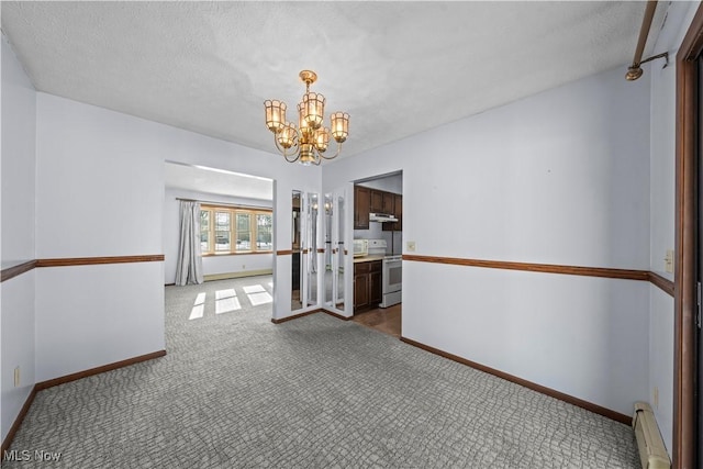 carpeted spare room with a baseboard radiator, an inviting chandelier, and a textured ceiling