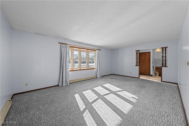 empty room with baseboard heating, light colored carpet, and a textured ceiling