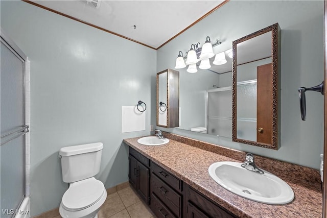 bathroom featuring tile patterned floors, vanity, ornamental molding, and toilet