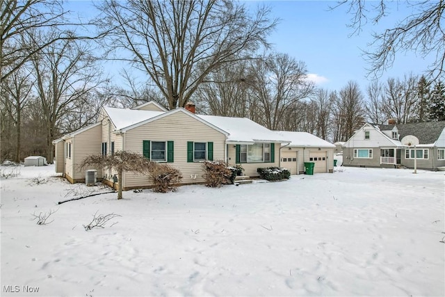 exterior space featuring a garage and central AC