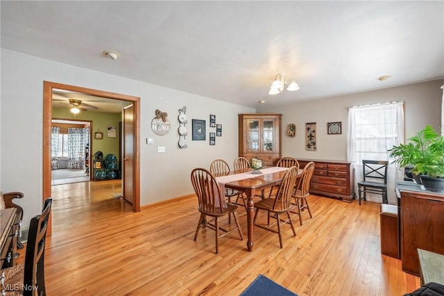 dining space featuring a chandelier and light hardwood / wood-style flooring