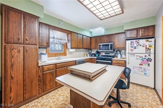 kitchen featuring a kitchen island, sink, a breakfast bar area, and appliances with stainless steel finishes