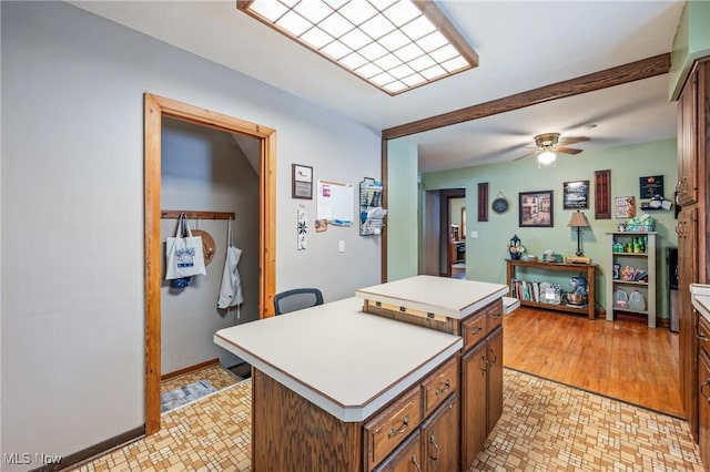 kitchen featuring ceiling fan and a center island