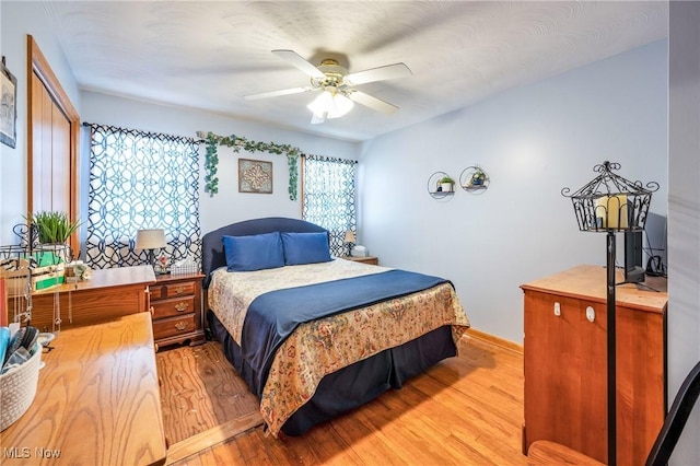 bedroom featuring ceiling fan and light hardwood / wood-style floors