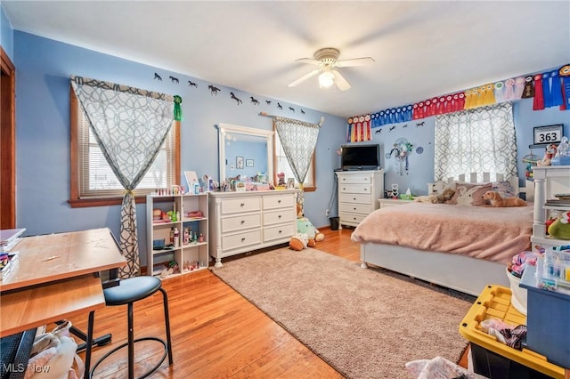 bedroom with ceiling fan and light wood-type flooring