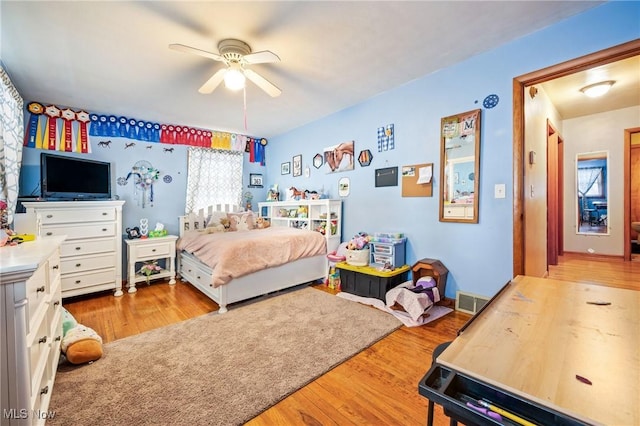 bedroom with ceiling fan and light hardwood / wood-style floors