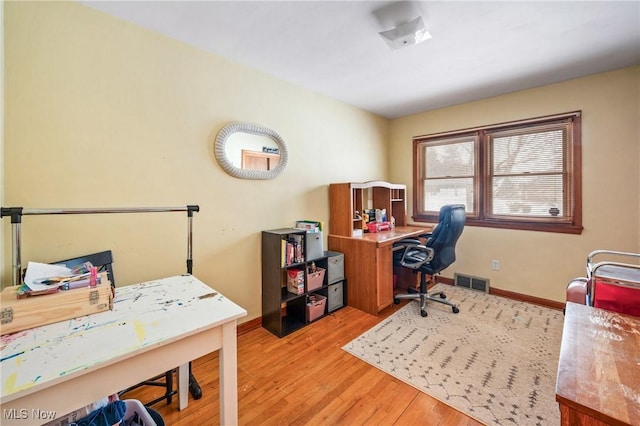 office with light wood-type flooring