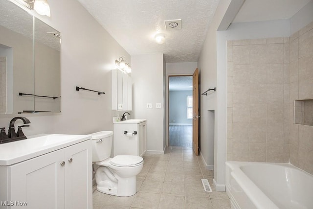 bathroom with a textured ceiling, toilet, vanity, and tile patterned flooring