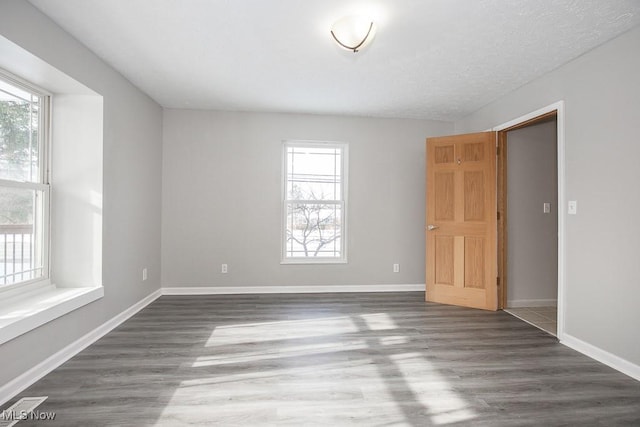 empty room featuring dark hardwood / wood-style floors