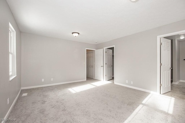 carpeted empty room featuring a healthy amount of sunlight