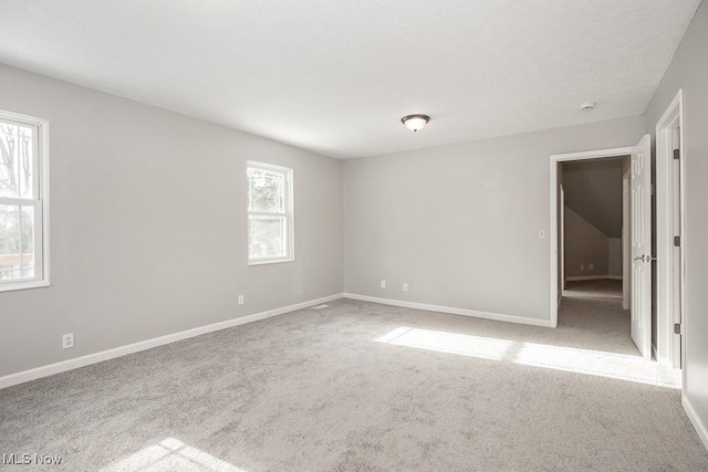 carpeted spare room with plenty of natural light