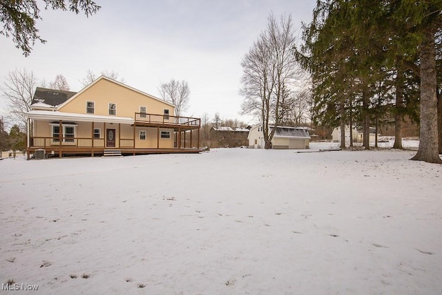 snow covered property with covered porch and central air condition unit