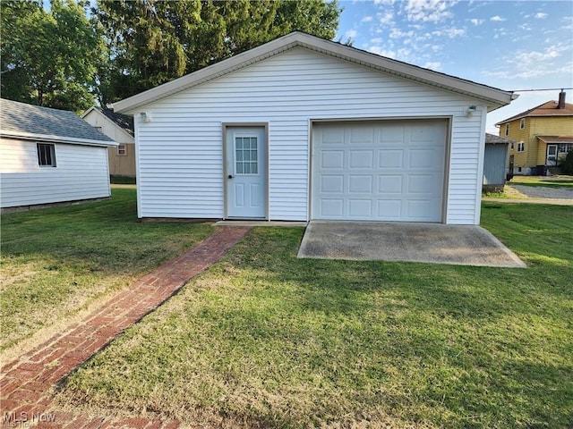 garage featuring a lawn