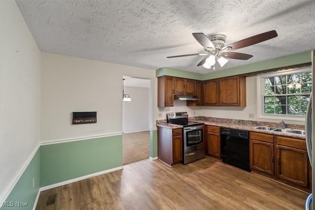 kitchen with light hardwood / wood-style flooring, dishwasher, hanging light fixtures, stainless steel electric range oven, and sink