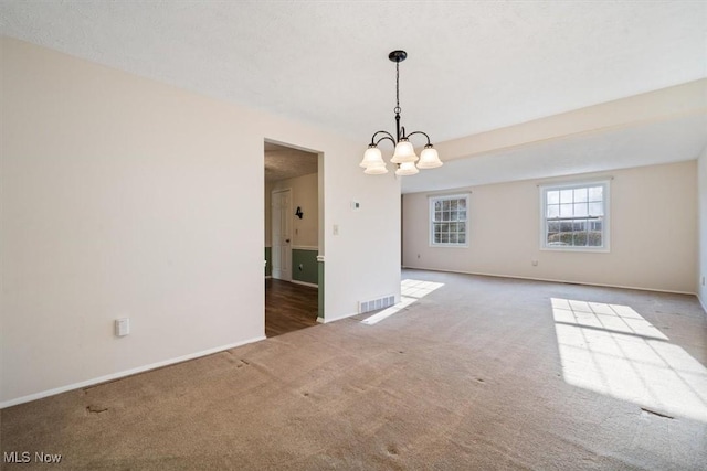 unfurnished dining area featuring an inviting chandelier and light carpet