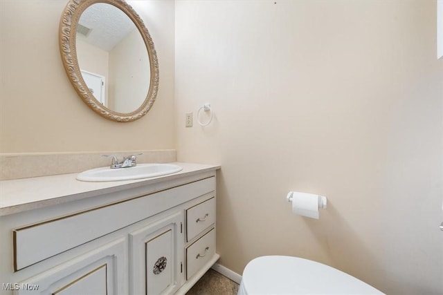 bathroom with toilet and vanity