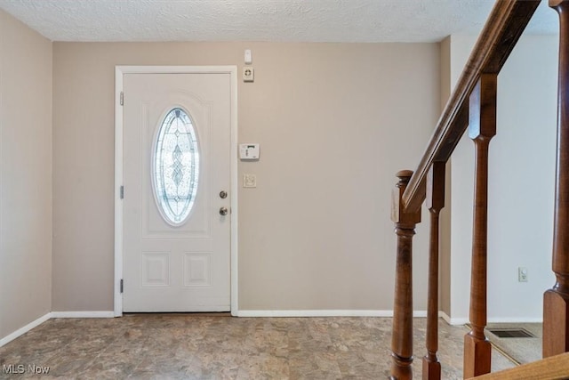 entryway with a textured ceiling