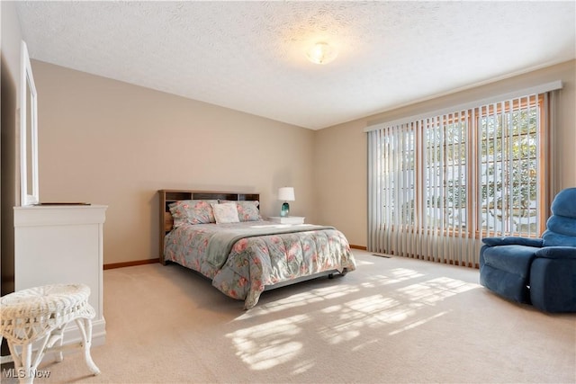 carpeted bedroom featuring a textured ceiling