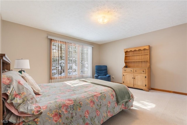 bedroom with a textured ceiling and carpet flooring