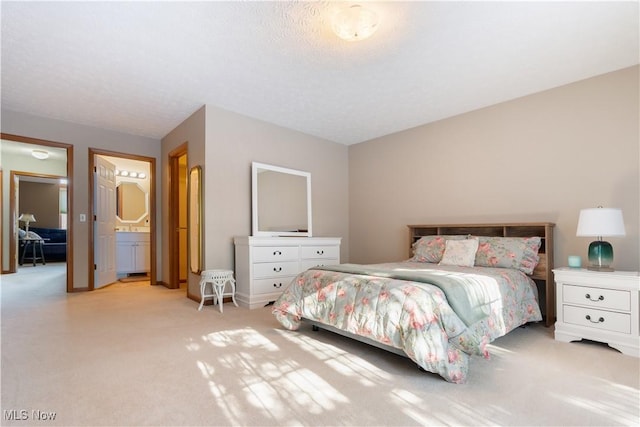 carpeted bedroom with ensuite bathroom