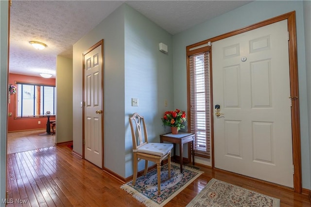 foyer featuring a textured ceiling and hardwood / wood-style floors