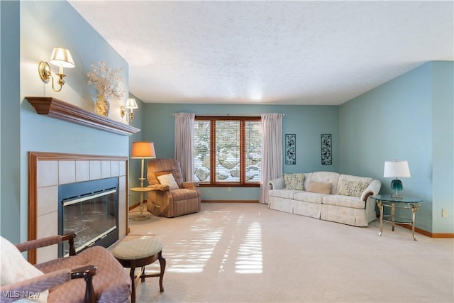 carpeted living room featuring a textured ceiling and a fireplace