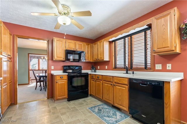 kitchen with black appliances, ceiling fan, a textured ceiling, and sink