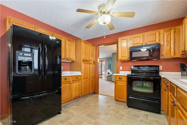 kitchen featuring black appliances, a textured ceiling, and ceiling fan