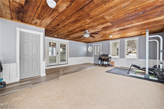 exercise area with ceiling fan, wooden ceiling, carpet, and french doors