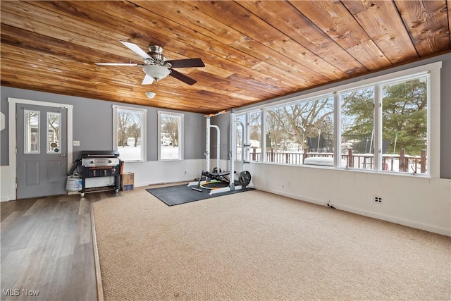 workout room featuring ceiling fan and wooden ceiling