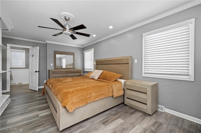 bedroom featuring ceiling fan, wood-type flooring, and ornamental molding