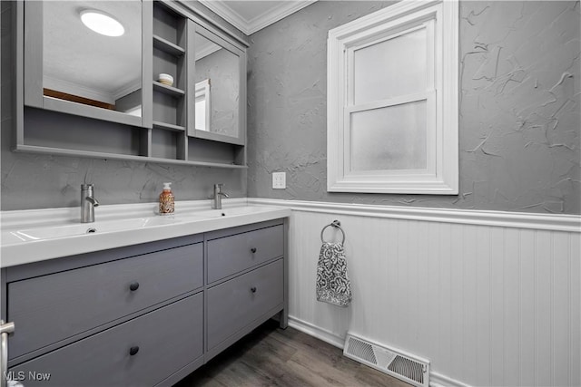 bathroom featuring hardwood / wood-style floors, vanity, and ornamental molding