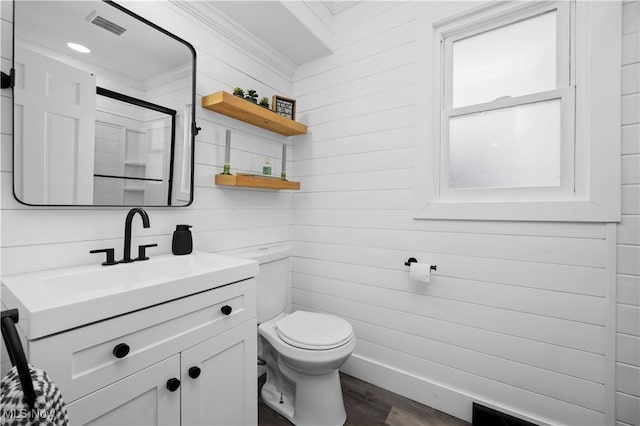 bathroom with a shower with door, hardwood / wood-style flooring, toilet, and vanity