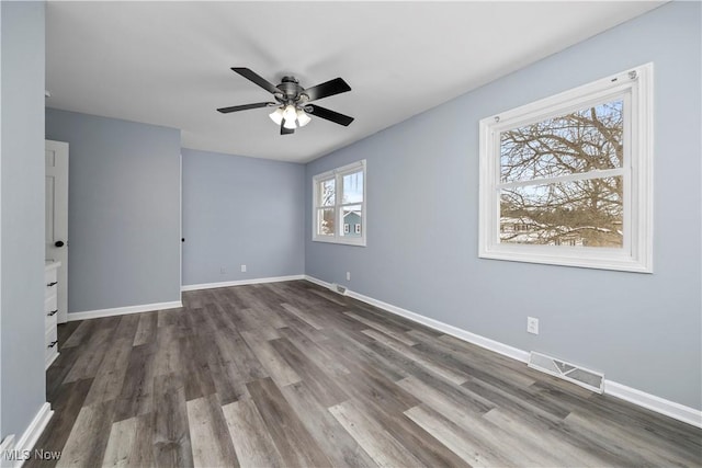 empty room featuring ceiling fan and dark hardwood / wood-style floors