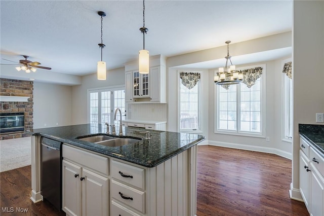 kitchen with dishwasher, a kitchen island with sink, sink, white cabinets, and dark hardwood / wood-style floors