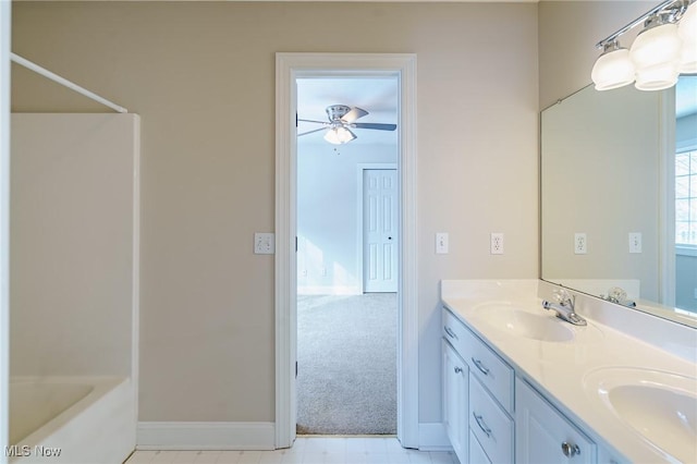 bathroom with bathing tub / shower combination, ceiling fan, and vanity