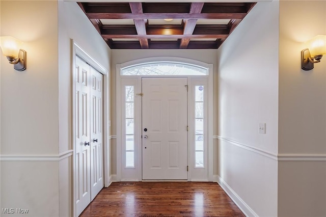 foyer featuring dark wood-type flooring, beam ceiling, and coffered ceiling