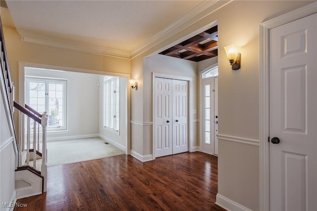 entrance foyer with beam ceiling, coffered ceiling, ornamental molding, and dark hardwood / wood-style floors